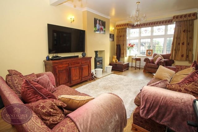 As well as the lounge, the Knowle Lane property boasts this cosy sitting room. There is a double-glazed bay window overlooking the back of the house and engineered wooden flooring.