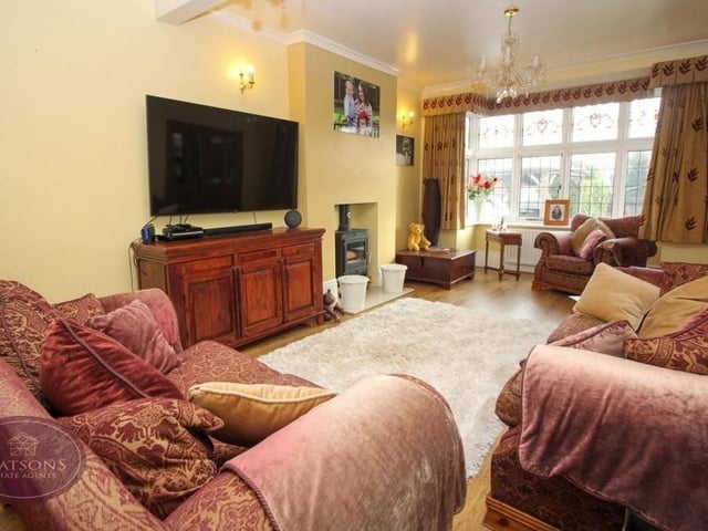As well as the lounge, the Knowle Lane property boasts this cosy sitting room. There is a double-glazed bay window overlooking the back of the house and engineered wooden flooring.