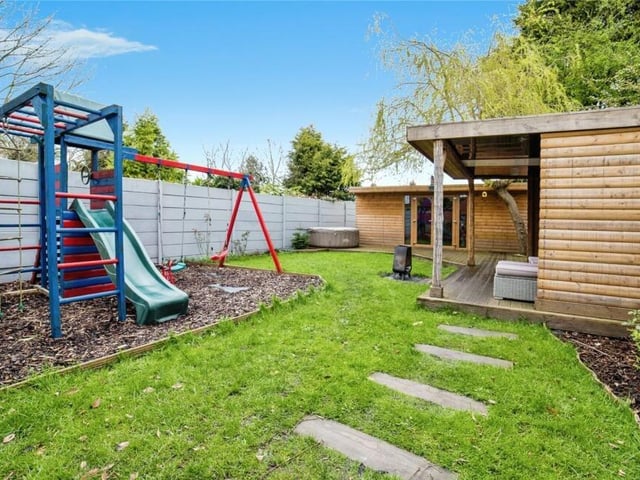 There is even space for some play equipment on a barked area within the busy rear garden.