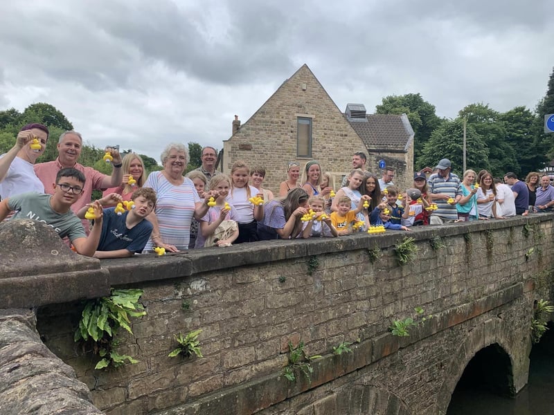 Residents gathered for a duck race raffle.