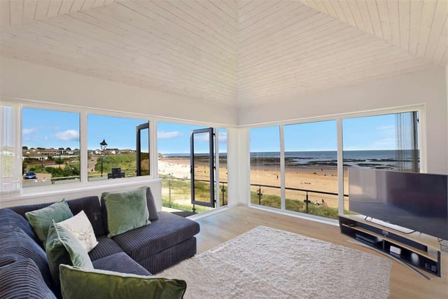 A delightful informal room with large double glazed picture windows which wrap around the side and rear providing direct views over the beach and sea. Double glazed French doors lead out to the balcony terrace.