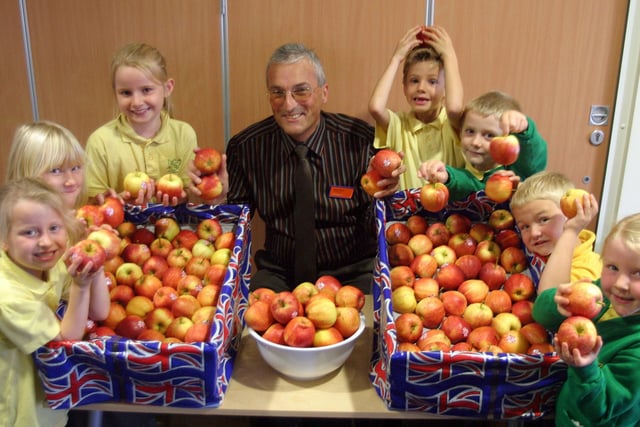 2007: Gilthill Primary School kids with apples from Kimberley Sainsburys as part of National Apple Week. Store duty manager Nigel Ward is also pictured.