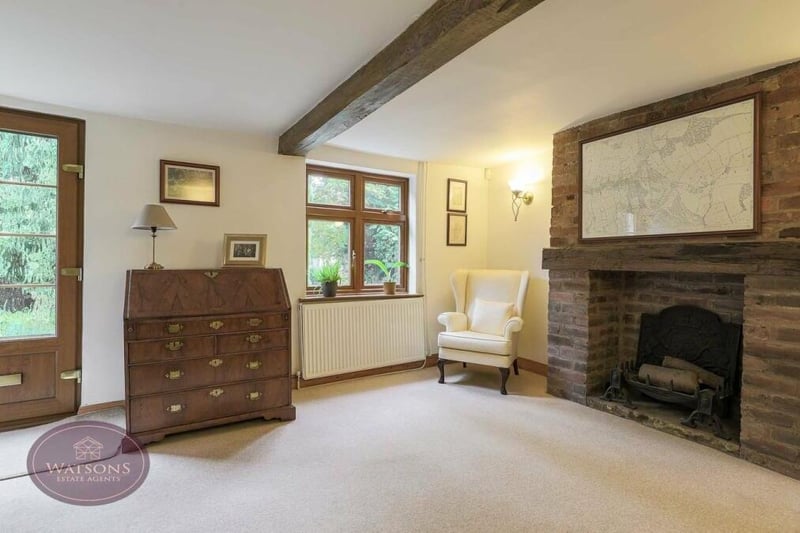 The front door of the property leads into the sitting room, which also features a storage cupboard.