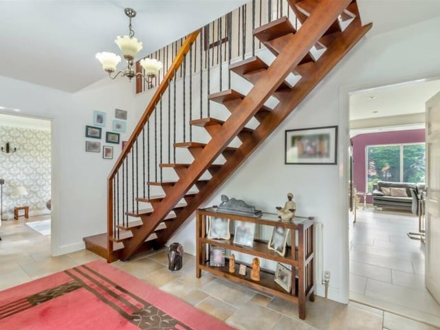 Time to check out the first floor, so let's pass through the entrance hall, with its tiled floor and striking staircase.