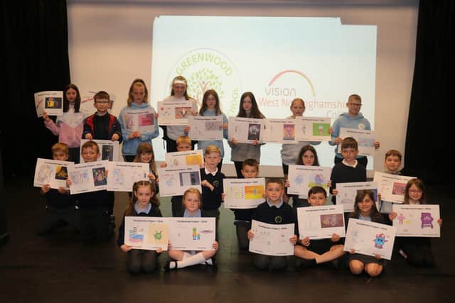 Pupils of Greenwood Primary School proudly display their illustrations