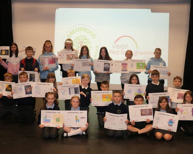 Pupils of Greenwood Primary School proudly display their illustrations