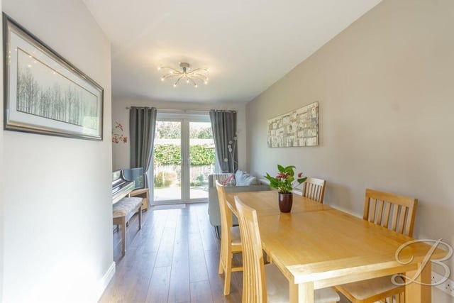 Sweep seamlessly from the kitchen into this welcoming dining room, which has laminate flooring and space for a dining table and small living area.