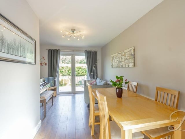 Sweep seamlessly from the kitchen into this welcoming dining room, which has laminate flooring and space for a dining table and small living area.