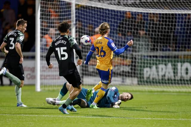 Will Swan has an early shot saved by Scott Loach.
