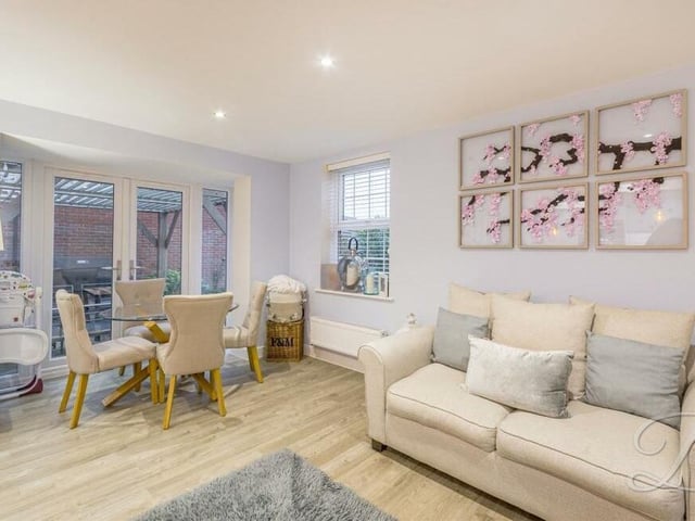 Here is the dining and living section of the kitchen area at the £550,000-plus property, complete with doors leading outside.