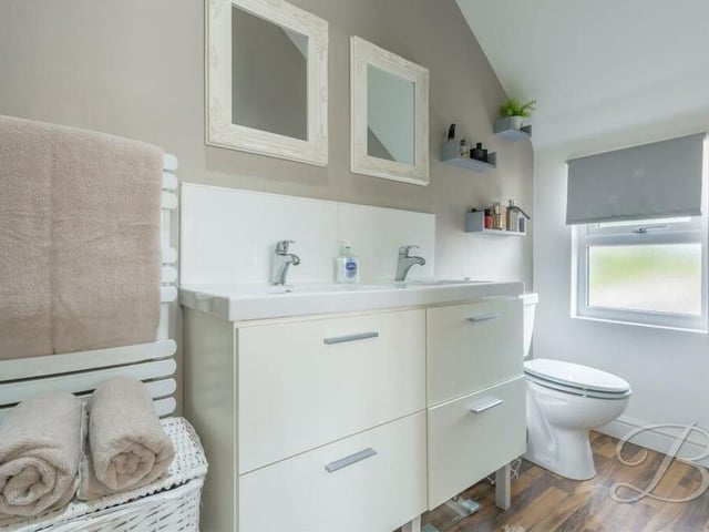 This is the first of two en suite shower rooms on the first floor of the West Hill Avenue house. Attached to the master bedroom, it is fitted with a shower cubicle, double wash hand basin, a low-flush WC, heated towel-rail and an opaque window.