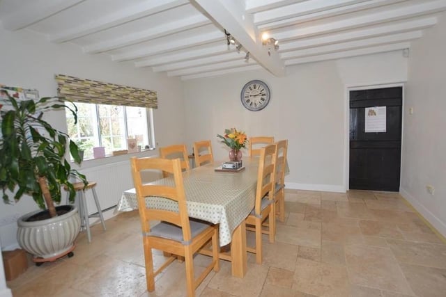 The dining area from a different angle. It is suitable for family meals or entertaining friends. Not far away is a utility room that has wall and base units, an inset sink, plumbing for a washing machine and space for a dryer. It also houses a Glow Worm central heating boiler with unvented hot-water cylinder.
