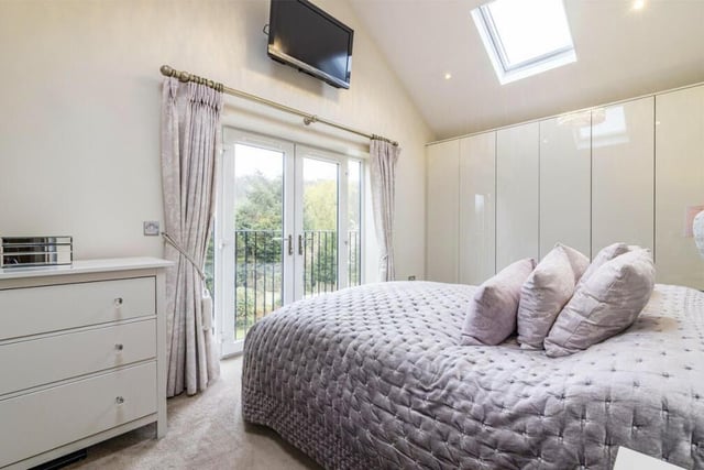 Moving upstairs now to check out the five bedrooms. Here is the master, which has extensive wardrobe space and also access to a Juliet balcony and an en suite shower room.