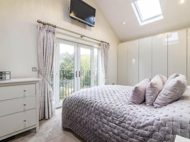 Moving upstairs now to check out the five bedrooms. Here is the master, which has extensive wardrobe space and also access to a Juliet balcony and an en suite shower room.