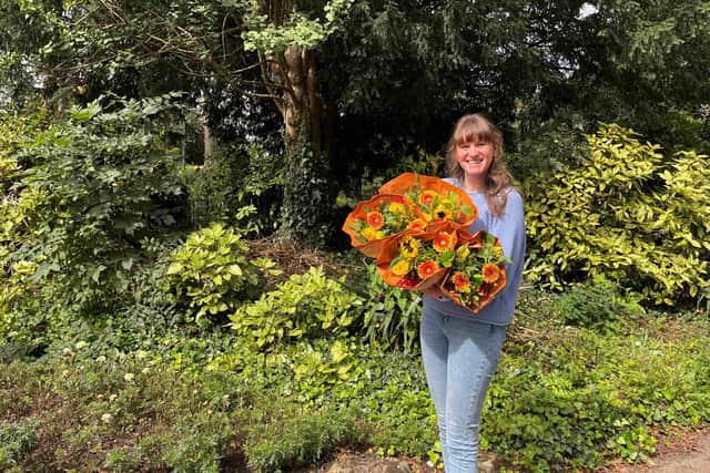 Bunches staff member Laura Platts with one of the bouquets handed out to people in Nottingham. Photo: Bunches