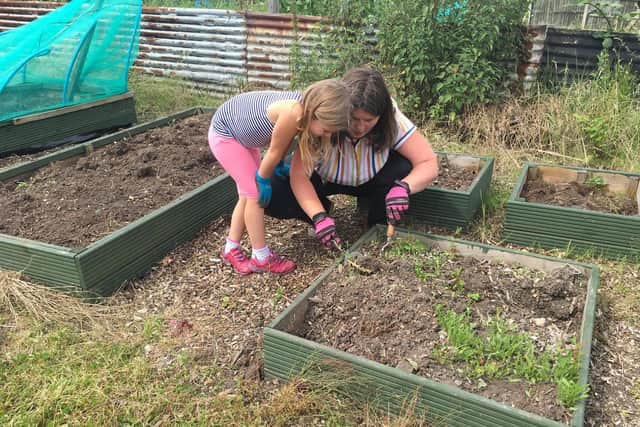 Zoe with her daughter, Georgie, working at the allotment.