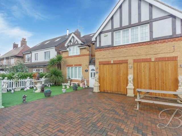 Returning to the front of the property, here is the gated, block-paved driveway that offers space for off-street parking. There is also an artificial lawn.