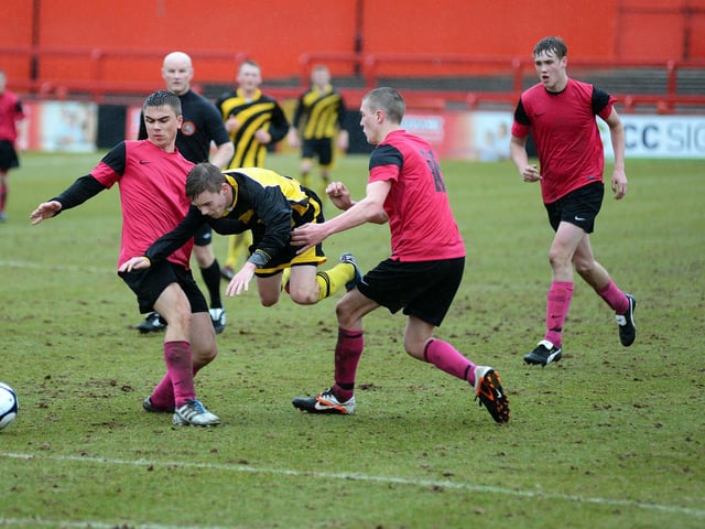 Pride of Shirebrook (pink strip) face Ashfield Scaffolding in the U18's final at Alfreton Town.