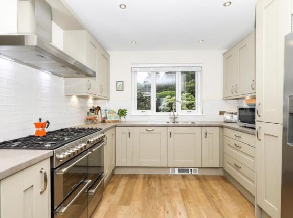 The kitchen affords space for a gas hob with electric range cooker and an American-style fridge freezer. There's also a breakfast bar and a pull-out pantry cupboard.