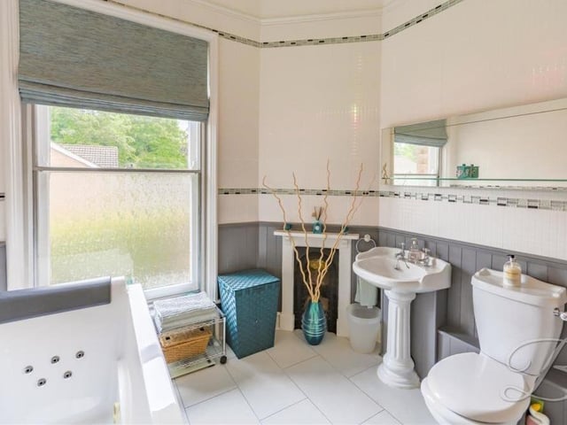 The en suite to the master bedroom is a delightful space. It includes a fitted jacuzzi bath, low-flush WC, hand wash basin, half-wood panelled wall and tiled floor.