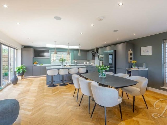 Our first port of call is the huge, open-plan kitchen, dining room and living area, which lends itself perfectly to entertaining all year round. It boasts herringbone wood flooring and underfloor heating.