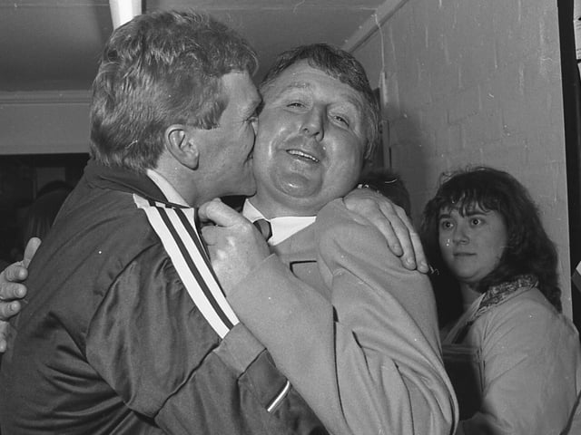 Boss George Foster celebrates with Alan Bostock from shirt sponsors Gunthorpe Textiles.