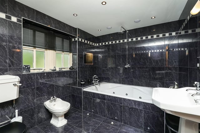 The family bathroom suite contains a Jacuzzi-style bath and a shower incorporating an inset television with ceiling speakers.