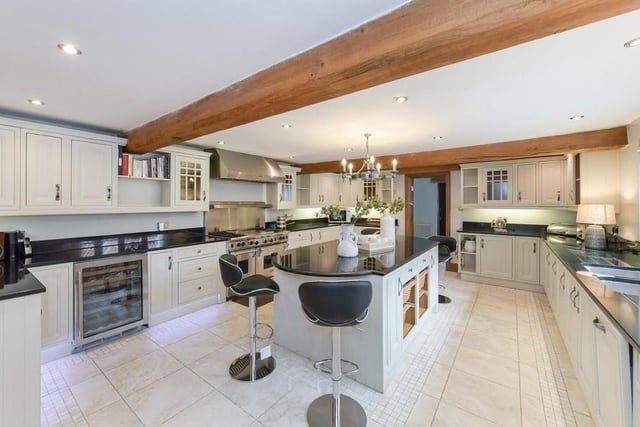 Let's move on now to the kitchen and breakfast room, which is newly fitted. It has an island and granite worktops, and looks out to an internal courtyard.
