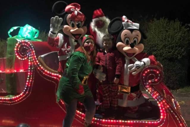 A lucky boy meets Santa and his elves, and Mickey and Minnie Mouse, at a previous Christmas celebration in Selston.