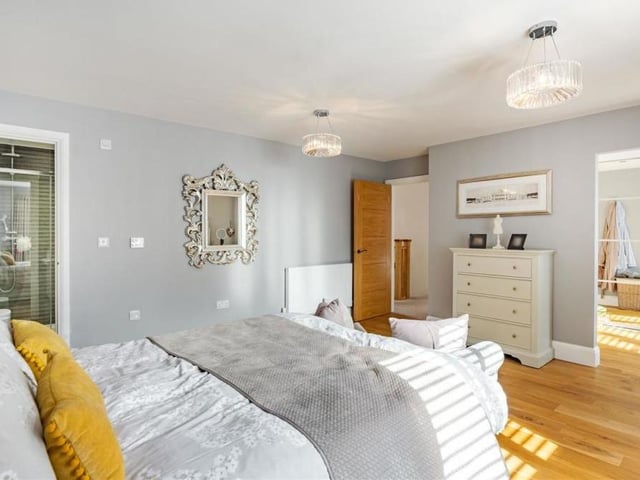 A second shot of the master bedroom, which is full of classy touches. See the en suite to the left and the dressing area to the right.