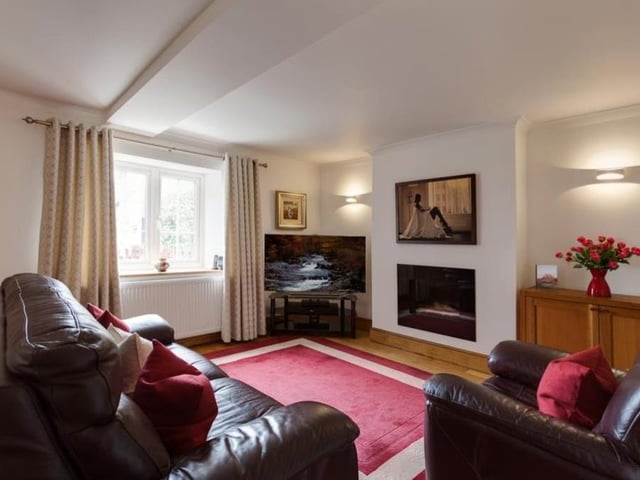 Completing the impressive set of ground-floor reception rooms is this relaxing lounge, which is a good size and faces the front of the Heath property. It features a contemporary, inset gas fire with a granite surround, and oak flooring.