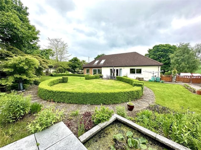 The property is situated to the centre of a 1/2-acre plot and is surrounded by a mature gardens, to the front, sides and rear; each section having its own theme. The rear garden has a large lawned area that is sectioned by bay trees and bordered by mature plants, shrubs, and trees. There are three ponds scattered throughout this beautiful outdoor space with several seating areas too. There is also a large double garage with storage to the rear, sectioned in two different parts.