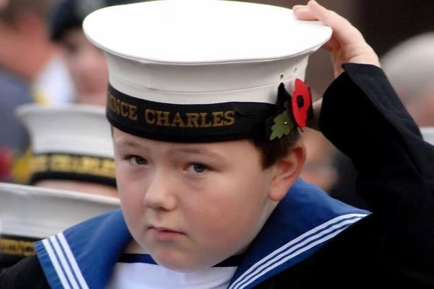 A young navy cadet adjusts his cap to get ready for the Remembrance service at the Civic Centre in 2009.