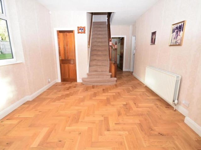 The rear hall has its own entrance from the driveway, meaning this part of the house could well be split off as an annexe. The stairs lead to two of the bedrooms on the first floor. The hall's floor is solid wood, and there is a useful cupboard beneath the staircase.