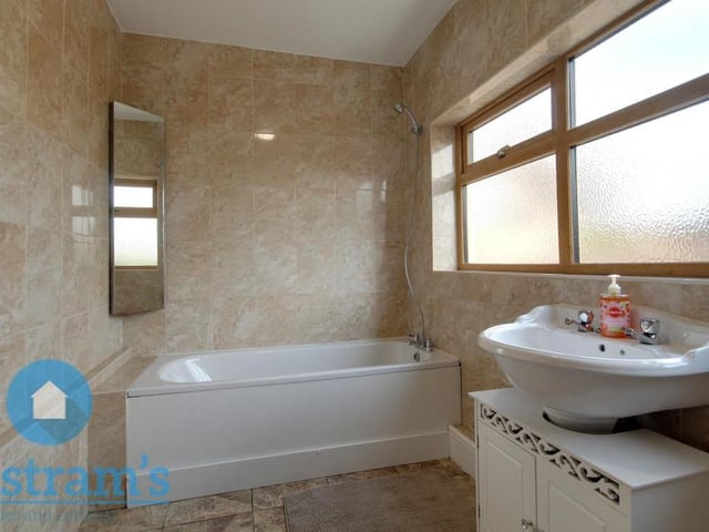 The Ollerton cottage's bathroom sits on the ground floor. A pleasant room, it comprises a fitted bath with shower above, sink basin, vanity unit, WC and full wall-tiling