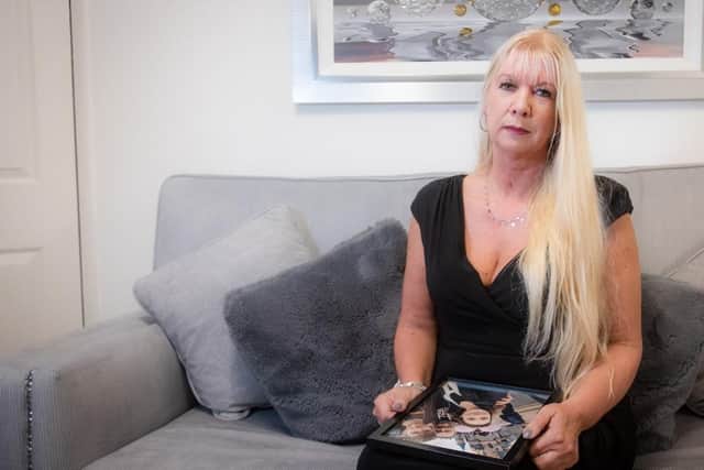 Clair Osborne with a picture of her late husband Mark and their children.