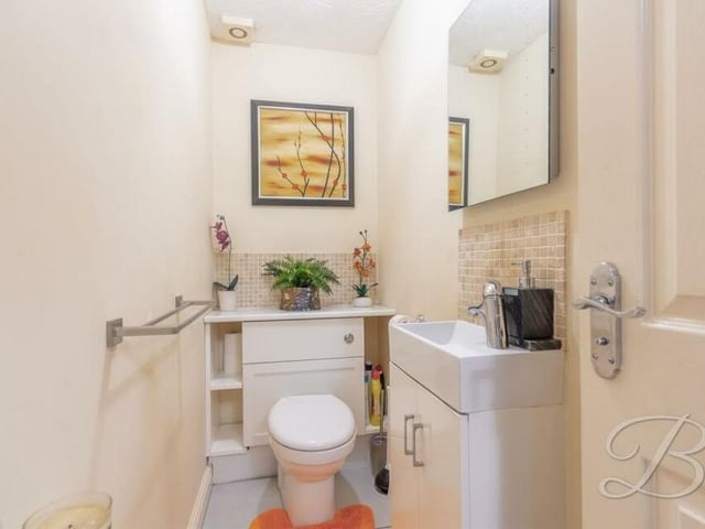 Completing our look at the ground floor rooms is this toilet, complete with a low-flush WC and vanity hand wash basin.
