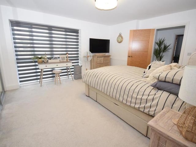 A large uPVC window, which overlooks the front of the Mansfield property, bathes the main bedroom in light.