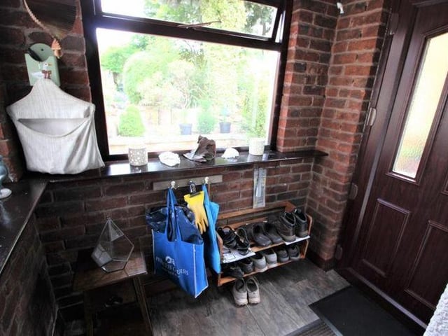 Before we step outside, let's pass through two porches at the property. There's an entrance porch, which leads into the lounge, and a side porch, which leads into the kitchen. Both have vinyl flooring.