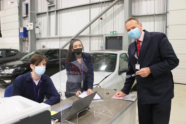 West Notts College students Benjamin Howcroft and Kimberley Caldicott with principal Andrew Cropley at the new WNC Autocentre.