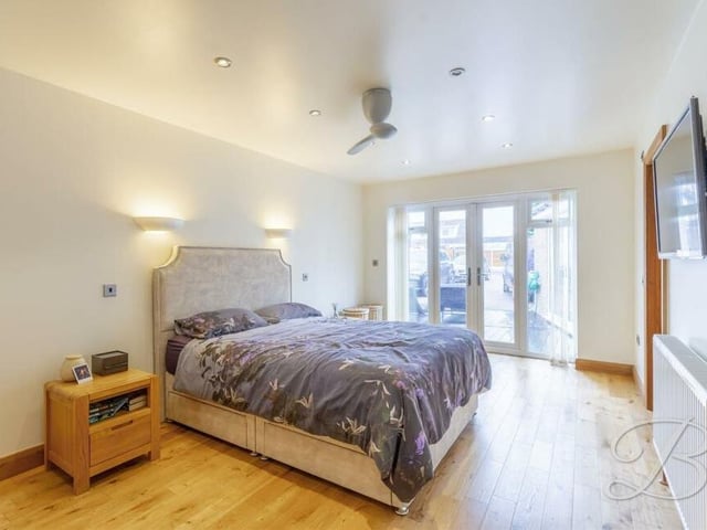 This is the main, and largest, bedroom at the £500,000-plus property. It has an oak floor, downlights, a walk-in wardrobe and French doors to the garden.