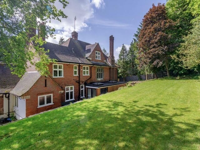 Let's step outside again now, and here is a view of the rear of the property, overseeing its raised lawn.