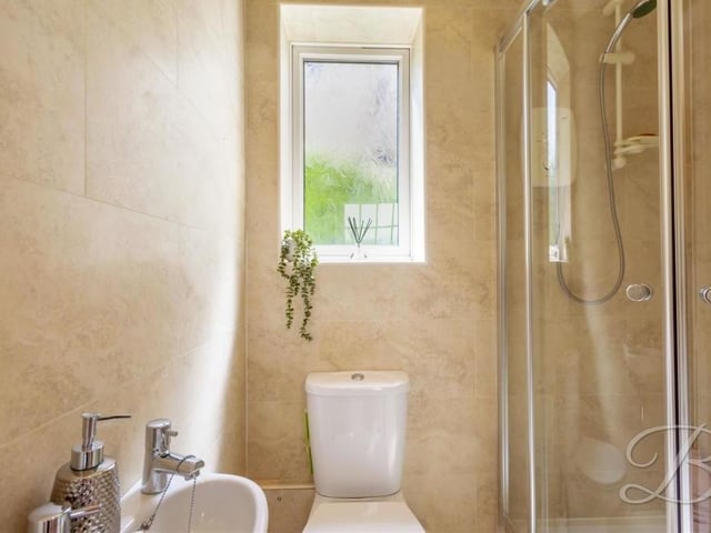The ground floor is completed by this shower room and toilet. It comprises a shower cubicle, low-flush WC and pedestal hand wash basin.