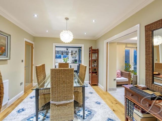 Sliding doors from the living room lead to this pleasant dining room, with coving and downlights. More sliding doors give access to the kitchen and orangery.