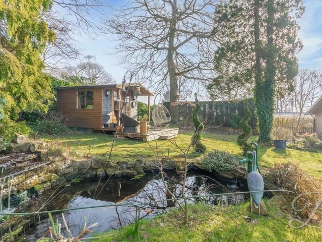 This pretty pond just has to be the jewel in the crown of the back garden, which also includes a workshop.