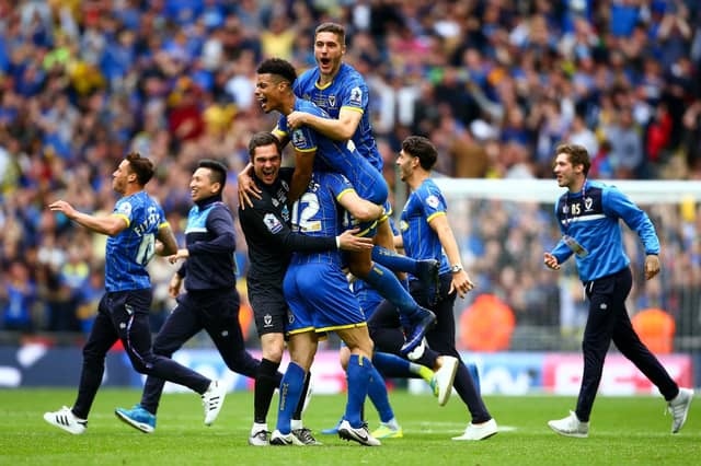 Seventh-placed AFC Wimbledon booked their place in League One with victory in the 2016 play-offs.