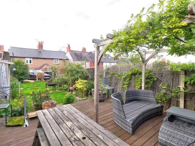 We have a handful of exterior photos to show you now, beginning with the extensive back garden that is mainly laid to lawn but also includes a decked seating area.