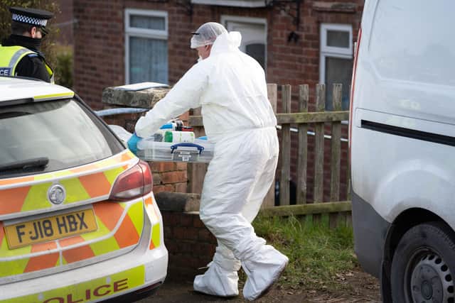 Police forensic officers at work in Warsop.