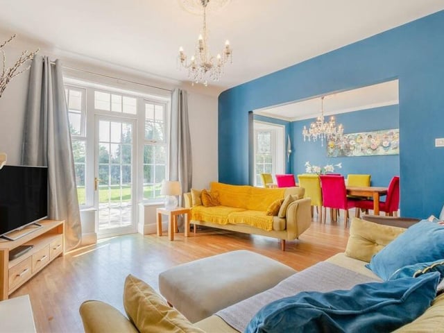 Next stop is this lovely lounge, which has a wood floor and a patio door leading out to the back garden. It backs on to the dining room.