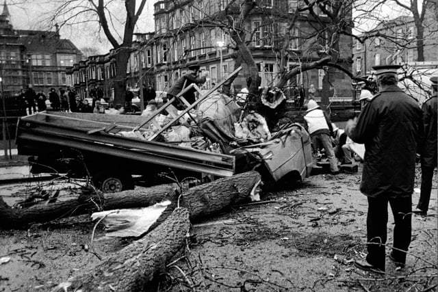 Firemen in the Meadows in Edinburgh where a 50-ft tree was blown down and fell on a truck, killing the driver Stanislaw Jakubanes of Largs. The passenger, Danuta Maj was trapped in the cab and broke both legs (December 1982)